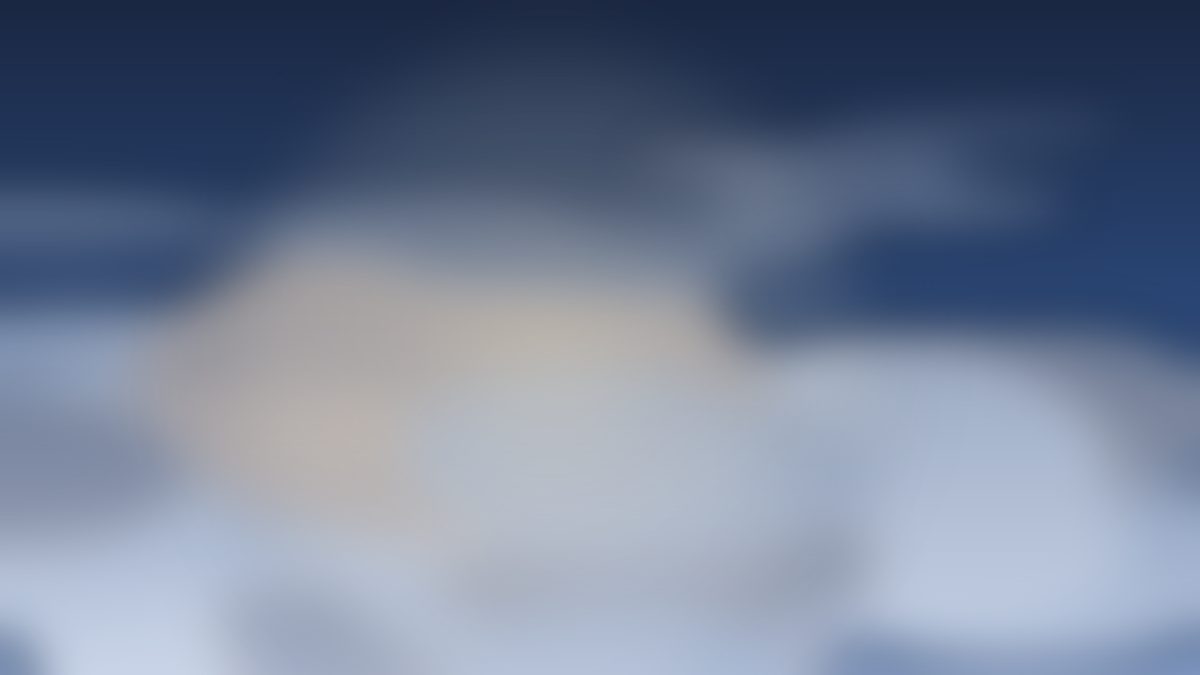 Deep blue clouds layered over fading light