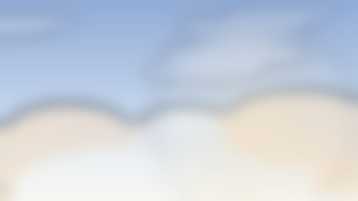 A clear morning sky with soft clouds